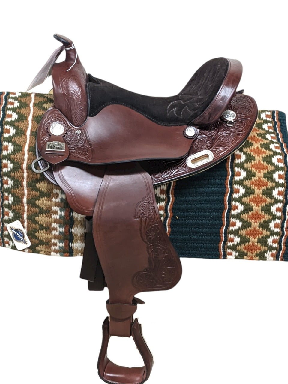 This saddle is at an amazing price point! The Big Horn A00908 Haflinger features in-skirt rigging, beautiful tooling complete with border tooling, and decorative conchos. The suede padded seat and padded stirrups make for a comfortable ride. This saddle has a 4" cantle, which is ideal for riders who like a higher cantle. Weight: Approx. 22 lbs Gullet: 7.5" mid-concho to mid concho Finished Seat Size: 17" Skirt Length: 23" Tree Size: 17.5"