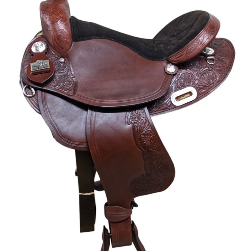 Saddle Features Reddish-toned smooth leather Padded black suede seat Floral tooling C-plate rigging Single rounded skirt Silver floral conchos Perfect for riding in the arena or out on the trail! Saddle Specifications Cantle height: 3" Horn height: 3" Skirt length: Approx. 24" (will slightly vary depending on seat size) Weight: 24 lbs Seat sizes available: 16" and 16.5" Gullet: 7"