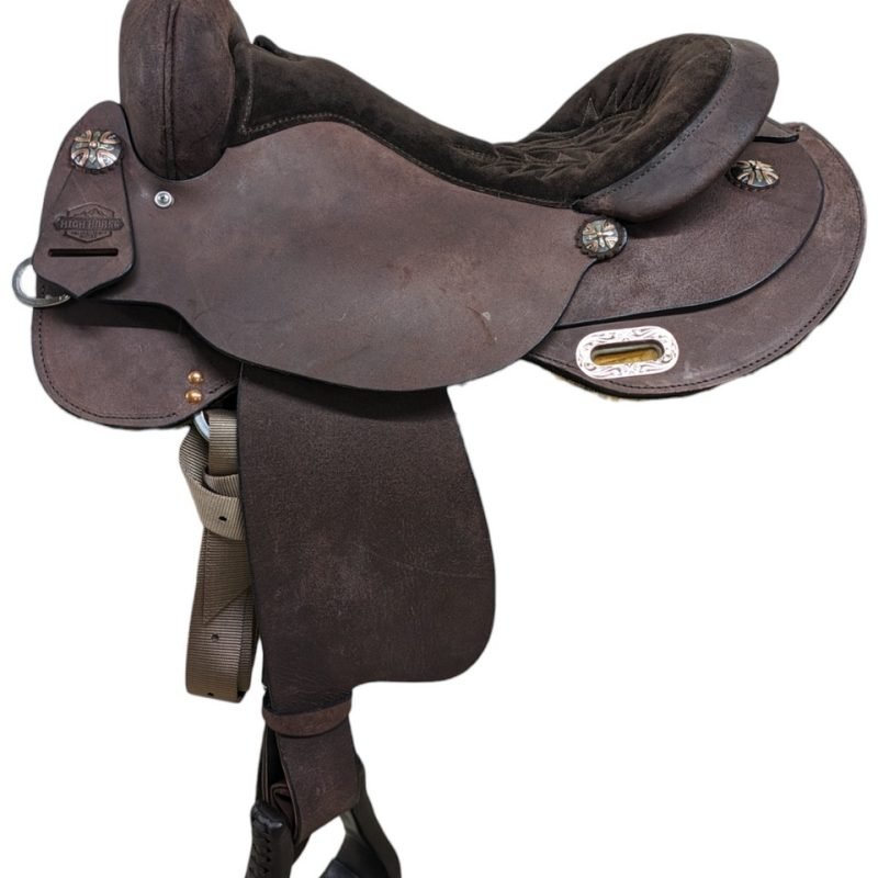 The 6315 Oakland Trainer has extra training dees to give you the tools you need for starting colts or tuning up your show horse. This saddle is custom made with rounded skirts to fit a variety of back lengths. Full roughout leather gives you extra stick in the saddle and is easy to care for. Pre-turned fenders help keep you balanced and provide additional comfort. All High Horse saddles are hand made in Yoakum, Texas – American Value, American Craftsmanship. Value priced, but handmade with all the style and quality of a higher-priced saddle. Take it straight to the arena! Saddle Features Full rough out saddle Chocolate finish Padded brown suede seat with matching brown quilt stitching Double rounded skirt with leg cutouts J plate rigging Mixed metal conchos Serial number: SP6315-770C-05-2 Includes leather wrapped stirrups Saddle Specifications Cantle Height: 4" Horn Height: 3" Skirt Length: Approx. 25" Weight: Approx. 24 lbs Tree Size: 17" Seat Size: 16.5" Gullet: 7" mid-concho to mid-concho