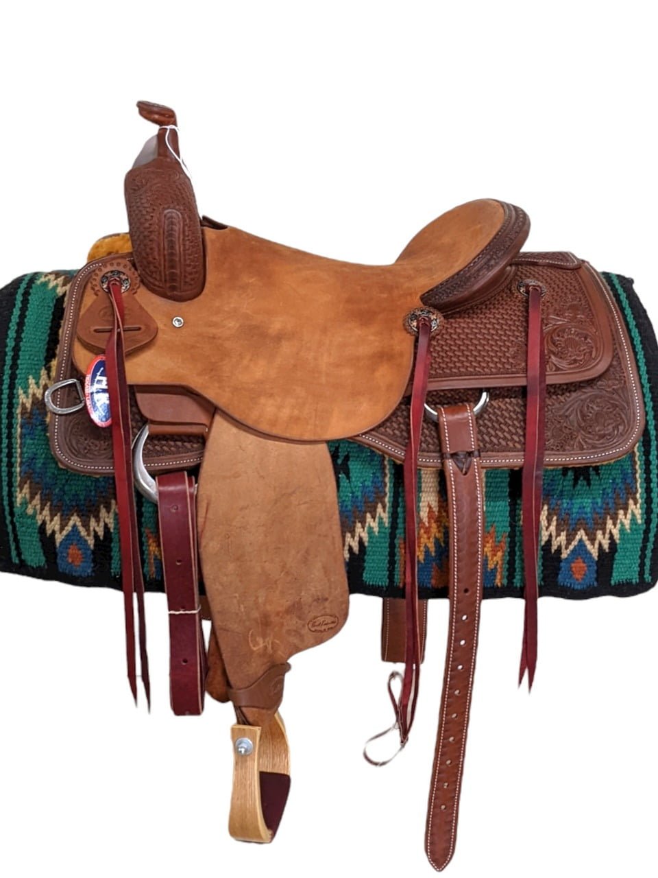 HR Saddlery's signature series ranch cutting saddle is exquisitely constructed. This saddle comes with a lifetime tree warranty and a real wool fleece bottom upgrade. The rough-out seat, seat jockey, and fenders keep the rider firmly in place. To keep the rider's gear close at hand, saddle strings are included. The swells, skirts, and cantle of the saddle are accented with a basket stamp and floral tooling. Weight: Approx. 40 lbs Gullet: 7" mid-concho to mid concho Finished Seat Size: 16" Skirt Length: 27" Tree Size: 16.5"