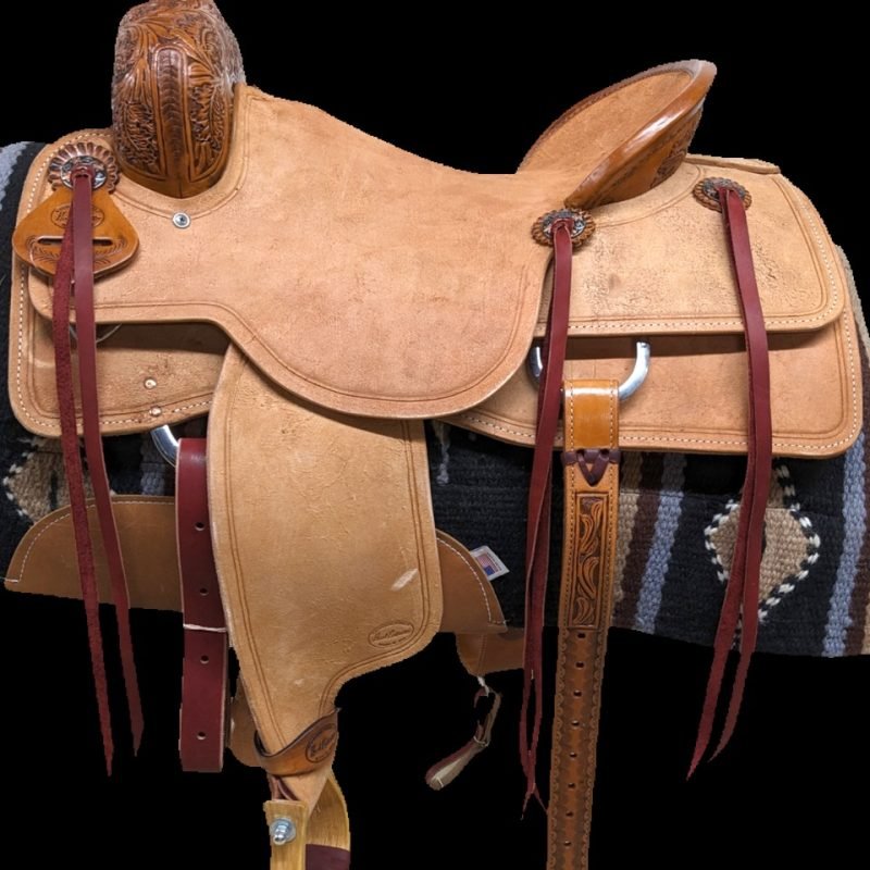 Ranch Cutter Light oil leather saddle Classy, western look Roughout leather and a leaf tooling Leather pencil roll cantle Hard seat Mixed metal slotted conchos Square skirts This saddle is lighter weight and comfortable Ready to go to work! Weight: Approx 33 lbs Gullet: 7" mid-concho to mid concho Skirt Length: 28" 17" finished seat 17" tree Lifetime tree warranty