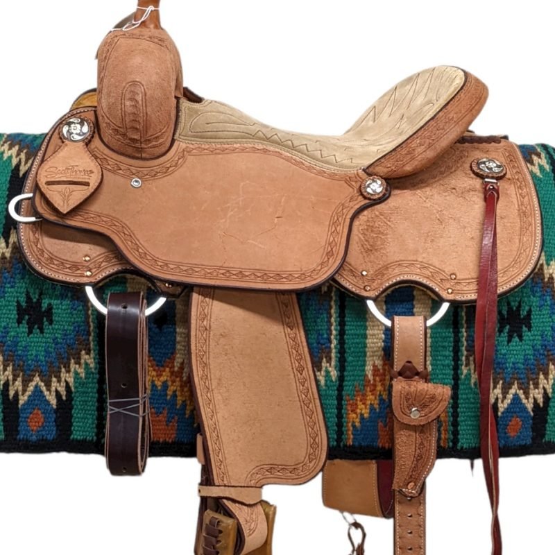 This light-oil all-around is both beautiful and durable. The seat of this saddle is gently cushioned and features a tan suede. Against the rough-out leather, a diamond border tooling stand out. The saddle has a single, rounded skirt. Comes with a back cinch and saddle strings. Weight: Approx. 33 lbs Gullet: 7" mid-concho to mid concho Finished Seat Size: 16" Skirt Length: 27.5" Tree Size: 16.5"